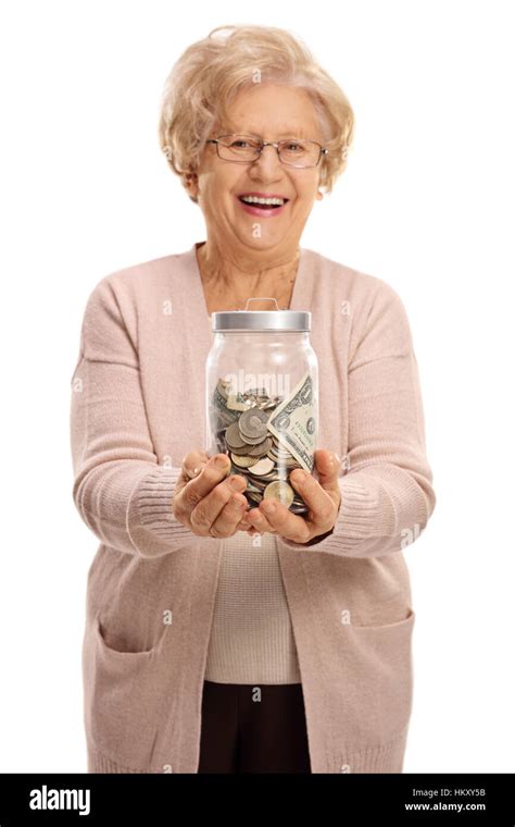 Overjoyed Mature Woman Holding A Jar Filled With Money Isolated On