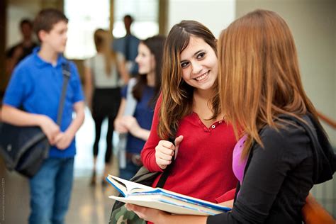 High School Friends Talking In Hallway By Stocksy Contributor Sean