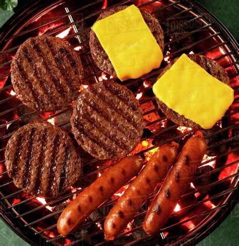 Hamburgers Cheeseburgers And Hot Dogs On A Grill From Above Stock