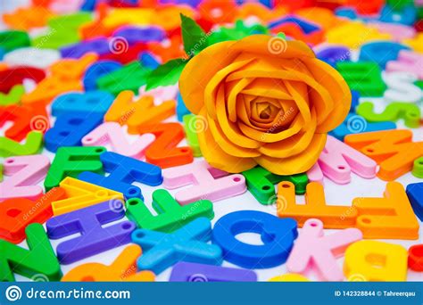 A Paper Rose Placed On Colorful Alphabet Blocks Stock Photo - Image of placed, blocks: 142328844