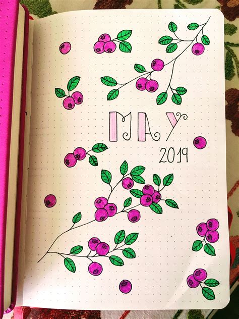 An Open Notebook With The Words May And Cherries Drawn On It Next To A