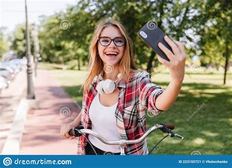 Pleasant Blonde Girl Using Smartphone For Selfie In Park Charming Smiling Lady In Glasses
