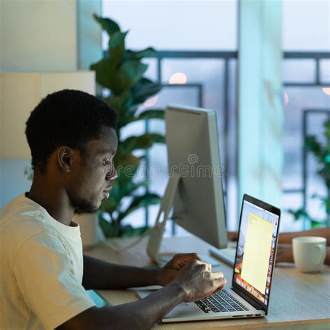 Concentrated African American Man Student Typing Email On Laptop