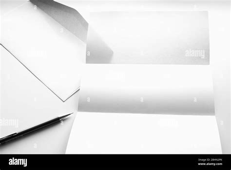 Blank Of Letter Paper And White Envelope With Pen Isolated On White