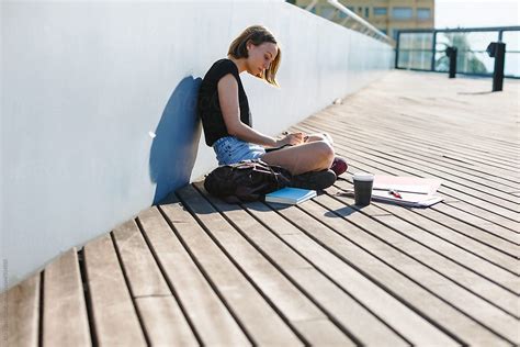 Young Student Working Outdoors By Stocksy Contributor Bonninstudio