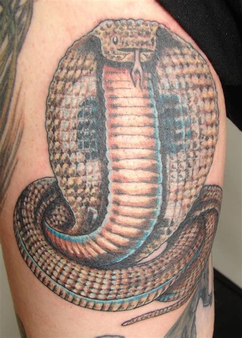 Cobra snake that looks like it's going inside and through the hand. Cobra Tattoos Designs, Ideas and Meaning | Tattoos For You