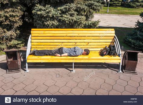 Man Sleeping On Park Bench High Resolution Stock Photography And Images