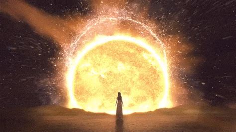 A Person Standing In Front Of A Large Object With Fire Coming Out Of It