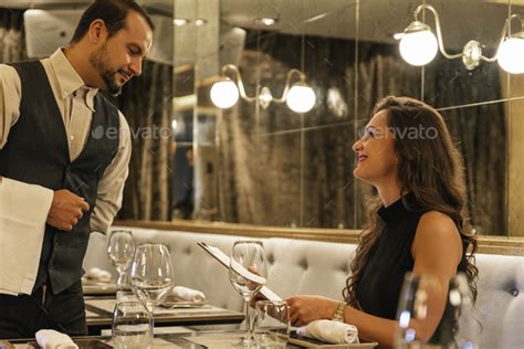 Young Attractive Woman Making Order At Restaurant Stock Photo By Nunezimage