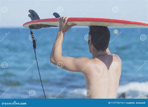 Handsome Surfer Holding Surfboard On Head From Rear Stock Photo Image