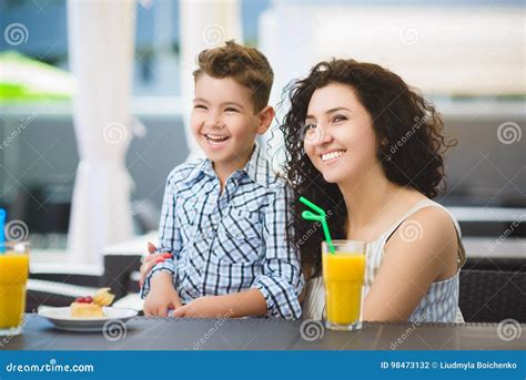 Boy And His Mother Tasting Dessert With Juice In Resort Restaurant Outdoor Stock Image