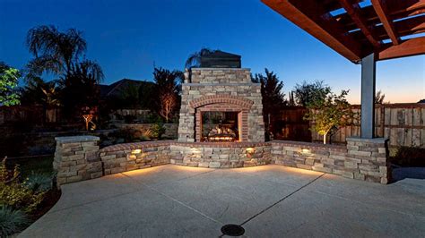 Outdoor fireplaces and fire pits create a warm and inviting area where guests can comfortably mingle and relax. Hardscapes - Mike's Evergreen, Inc.