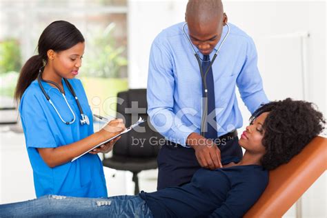 African American Doctor Examining Female Patient Stock Photo Royalty