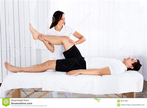 Young Female Masseur Giving Leg Massage To Man Stock Image Image Of