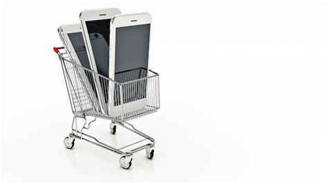 Premium Photo Two Iphones In A Shopping Cart With One Being Held Up