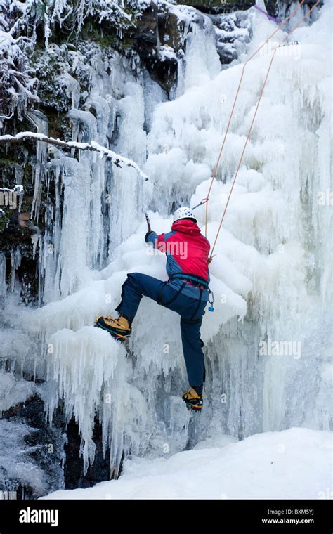 Climber Doing An Ice Climb On A Frozen Waterfall Lynn Falls In North