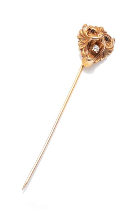 An Antique Gold And Diamond Stick Pin In The Form Of A Lions Stick