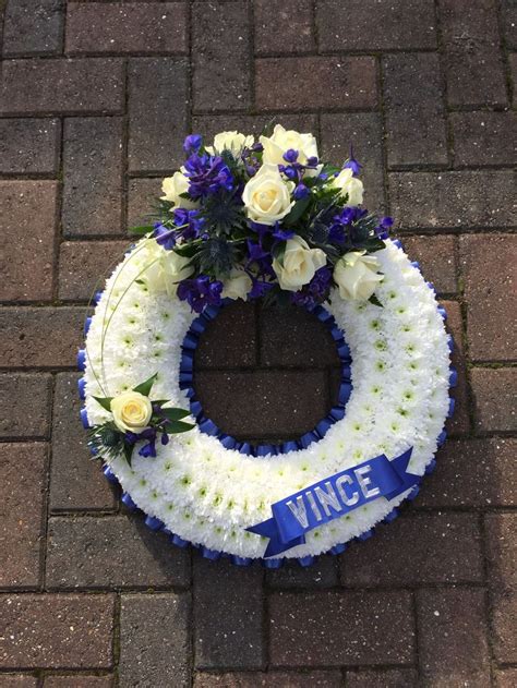 White And Blue Wreath With Rose And Delphinium Detail Funeral Flowers