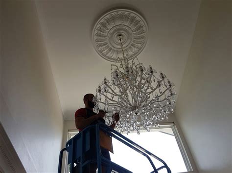 Installing a chandelier and dimmer switch. Chandelier Installation - All Star Services Australia