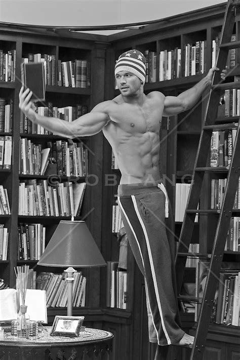 Sexy Man At Home With A Great Body Reading A Book In A Home Library