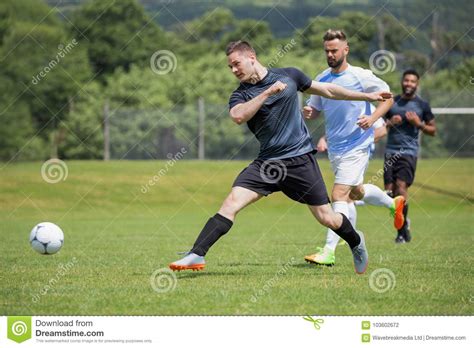Football Players Playing Soccer in the Ground Stock Photo - Image of