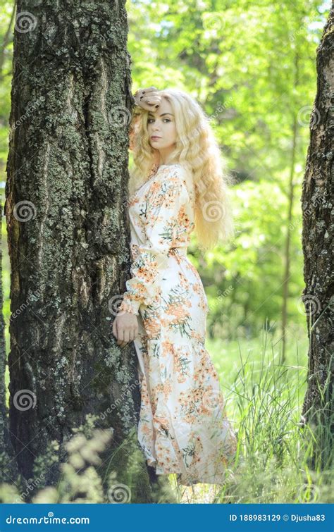 Picture Of Blonde Girl With Curly Hair In The Forest Stock Image