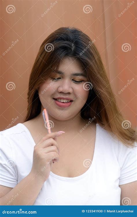 Portrait Of Asian Pretty Smiley Face Fat Woman Pose And Thinking Stock