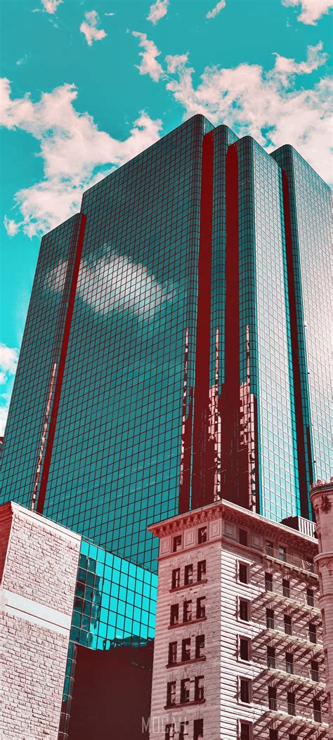 274322 Turquoise Sky Frames A Reflective Downtown Office Building