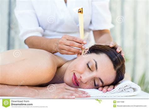 Relaxed Brunette Getting An Ear Candling Treatment Stock Photo Image Of Health Pampering