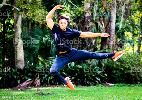 Handsome Young Black Male Professional Ballet Dancer Practices Jumps
