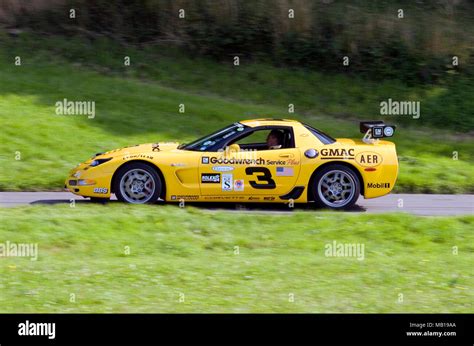 Yellow Chevrolet Corvette Racing Car In Profile Side View And Driving