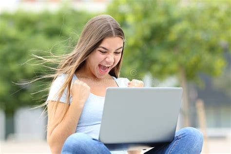 Excited Teen Checking Laptop In The Street Stock Photo Image Of