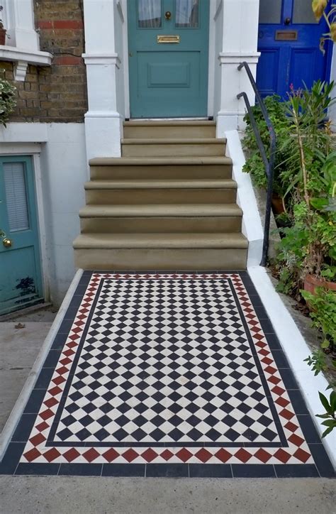 Because natural stone comes out of the earth. Bull Nose York Stone Steps and Victorian Mosaic Tile Path - London Garden Design