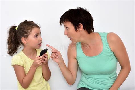 Angry Mother Scolding Her Daughter With Smartphone Stock Photo Image