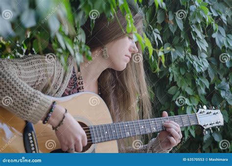 Blond Long Haired Girl Playing An Acoustic Guitar Stock Image Image