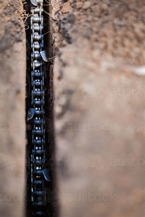 Image Of Trencher Chain Blade Digging Hole In Dirt Austockphoto