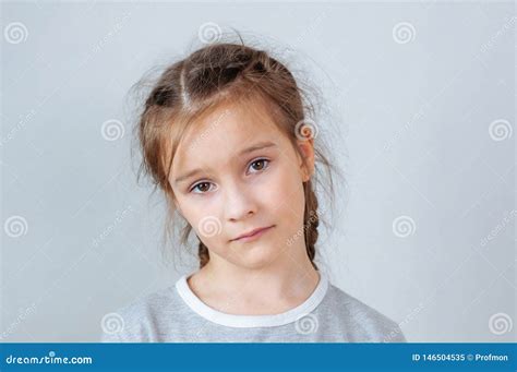 Studio Emotional Portrait Of A Serious Little Girl With Long Hair Stock