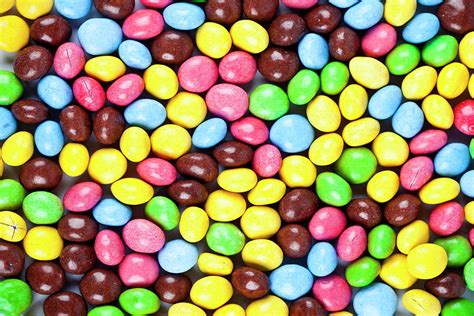 Pile Of Delicious Rainbow Colorful Chocolate Candies Background