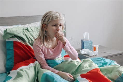 Sick Ill Kid Girl With Fever Lying In Bed At Home With Flu Fever