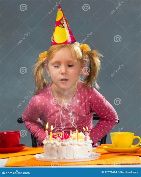 Girl Blowing Out Candles Stock Images Image 22572694