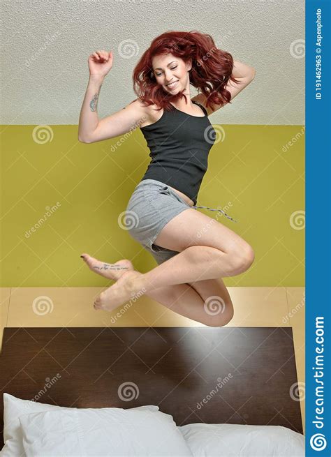 Young Woman Jumping In Bed Stock Image Image Of Bedroom 191462963