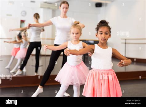 Dance Teacher Helping Her Little Girls Students Stock Photo Alamy