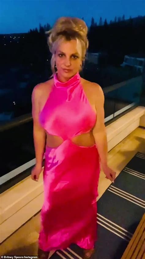 Britney Spears Showcases Her Figure In Hot Pink Satin Cut Out Dress As She Poses On A Balcony