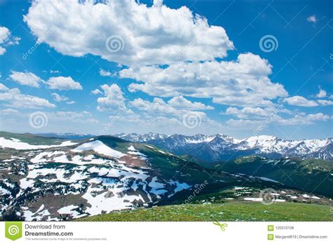Beautiful Colorado Spring Landscape With Green Meadows And Snow Covered