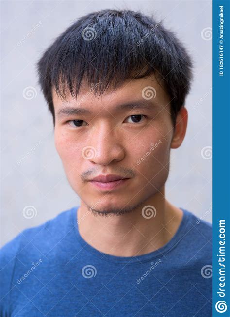 Face Of Young Asian Man Against Concrete Wall Stock Image Image Of