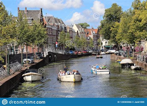 Visit the sight where the very first tulips were planted in holland! Boating In A Canal In Leiden, Holland Editorial Photo ...