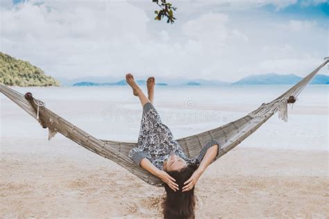 Woman Relaxing In The Hammock With Her Feet Up In Tropical Beach On