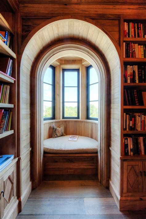 Arched Opening Into Curved Bay Window Seat In Natural Wood Library
