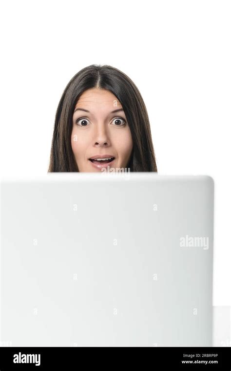 Businesswoman Looking Over The Top Of Her Computer Screen At The Camera