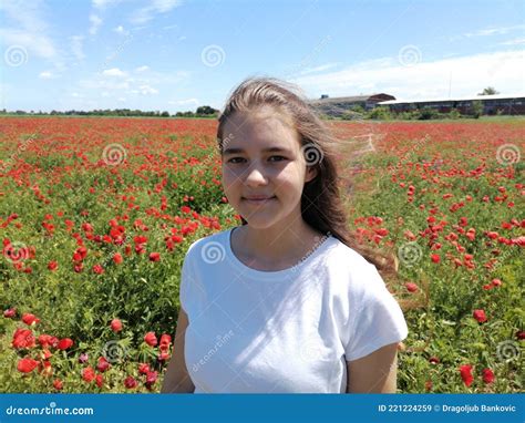 Beautiful Girl In A Field Of Blooming Red Flowers Wonderful Landscape